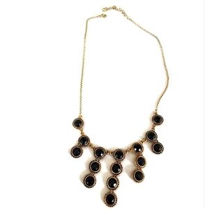 gold toned black button bib.statement piece